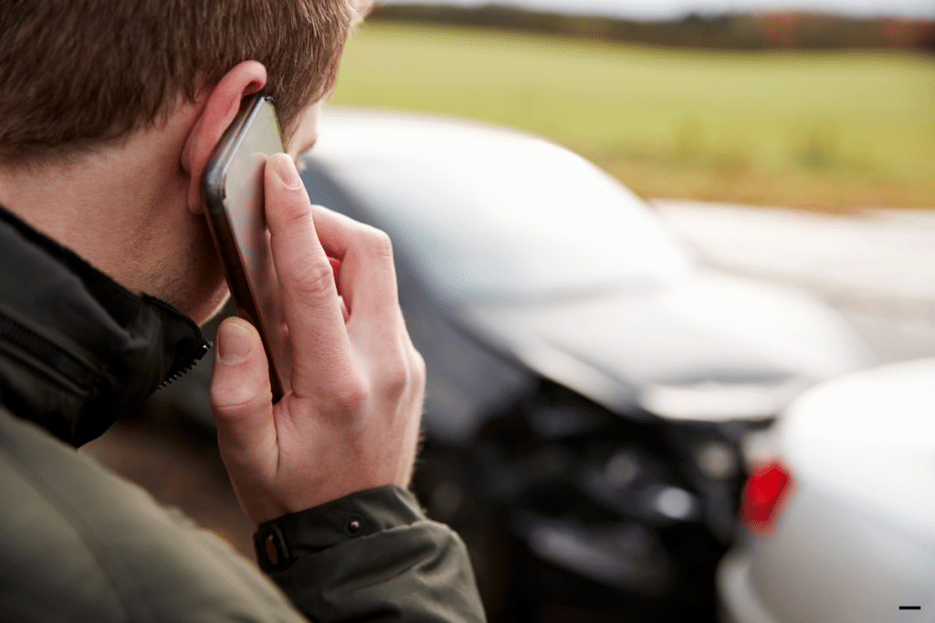 A man making a call at the accident scene