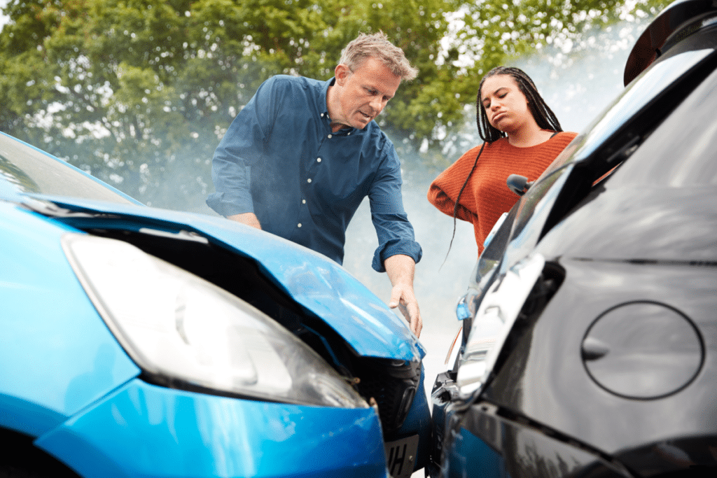 A man and lady discussing their accidented vehicles